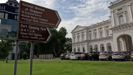 person walking past a historic museum building