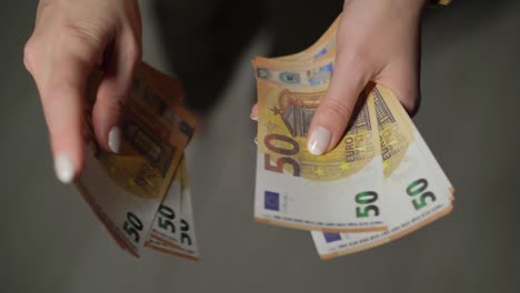 person counts money. currency cash, finance. woman holding euro banknotes