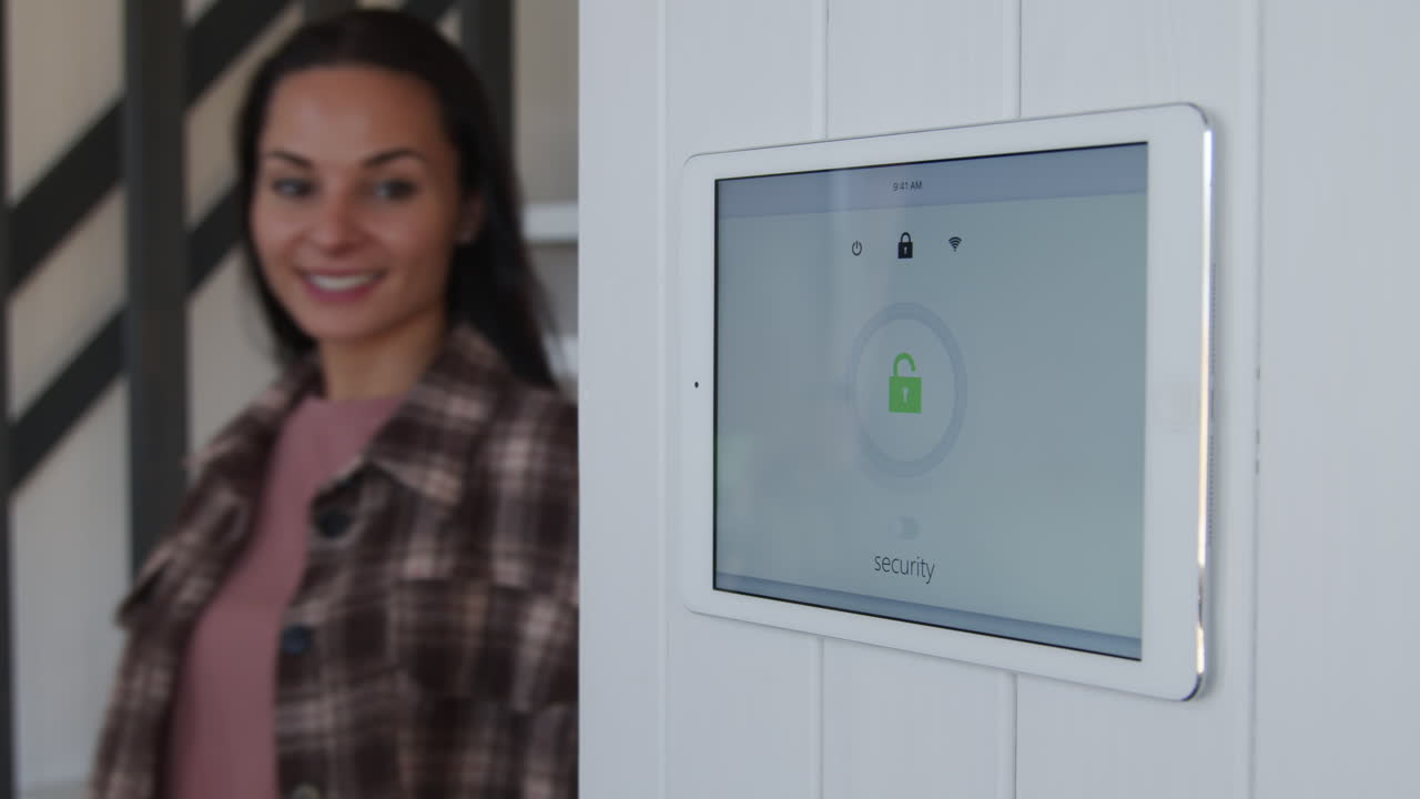 Woman Turning Smart Home Security System On