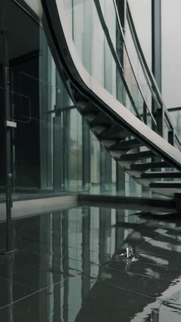 water droplet ripples on reflective floor in modern building interior