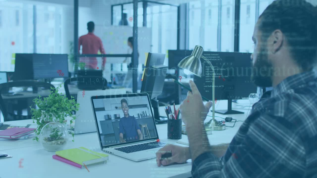 Office worker joining remote call on laptop, raising hand and adjusting lamp as coworker writing