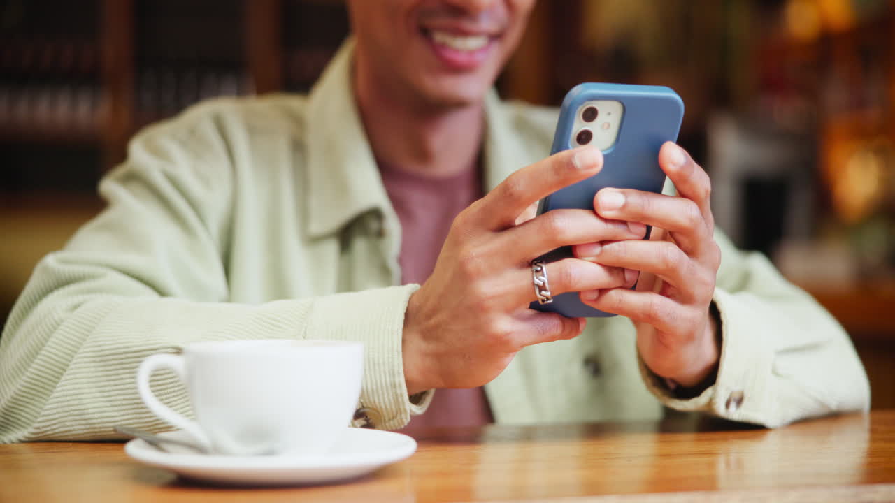 Man using phone at cafe