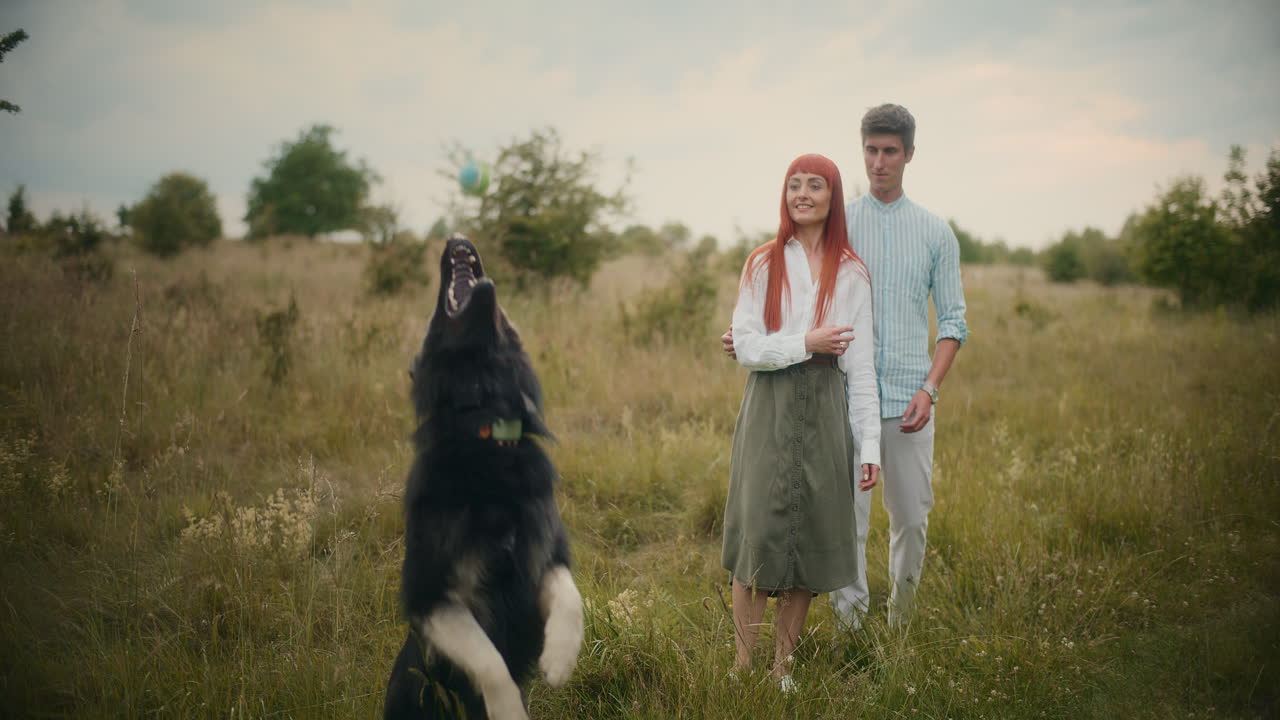 Couple with dog in a field
