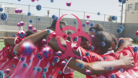 animation of virus cells and biohazard symbol over diverse male rugby players teaming up