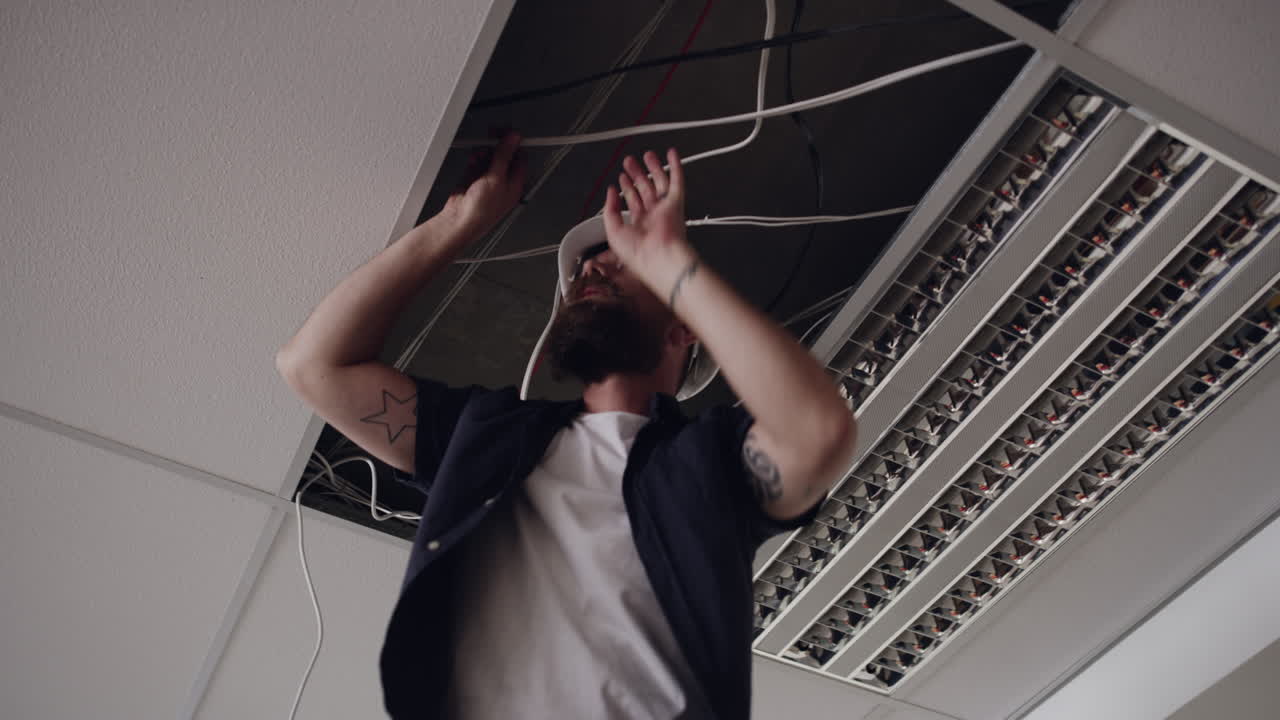 Electrician Working on Ceiling