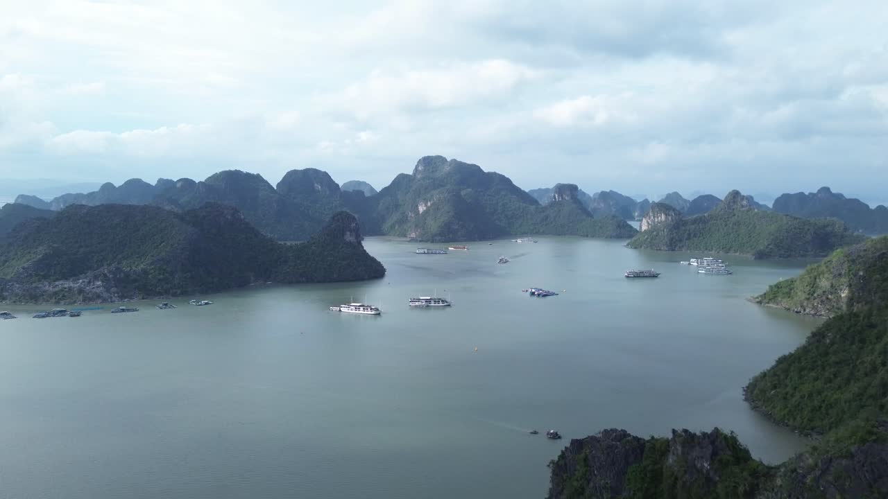 Zoom in movement above boats and dramatic karst landscape in Cat Ba Bay