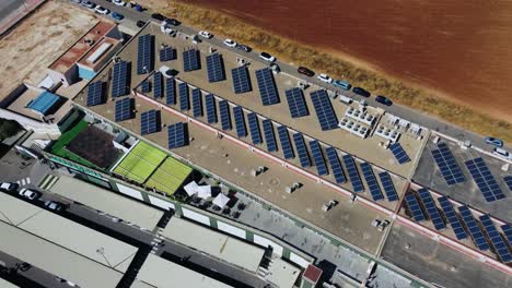 aerial view of solar panels array on rooftop of shopping mall, green energy concept, drone shot