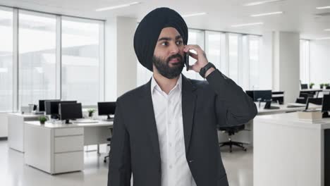 serious sikh indian businessman talking on call