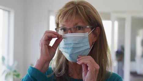 senior woman wearing face mask at home