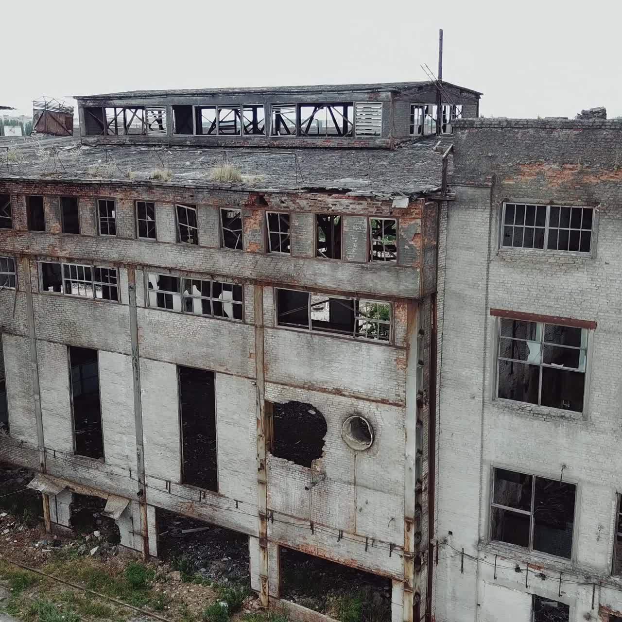 Aerial view from the air to an abandoned factory. Old industrial building for demolition.