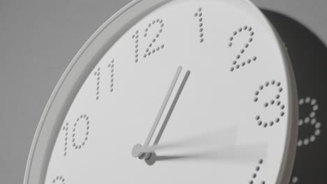 dotted white clock face on grey wall all day