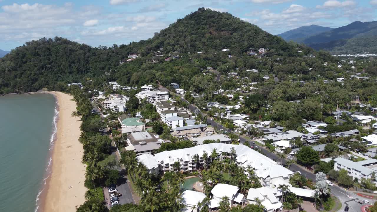 4K Aerial video of a small beachside town with luxury hotels next to a sandy beach in Australia