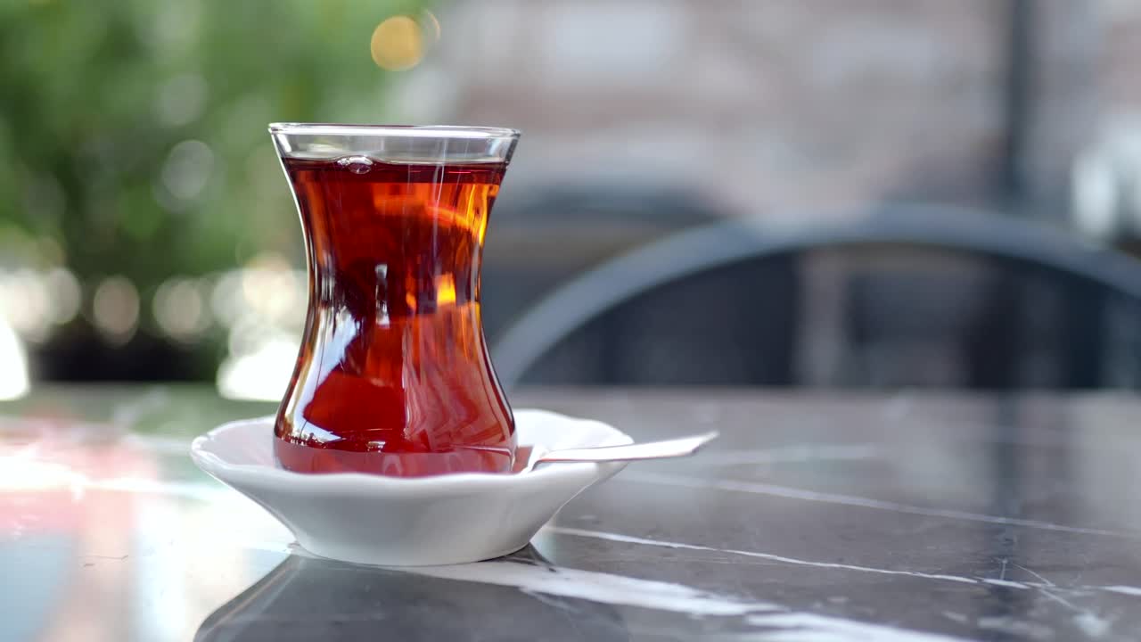 Traditional Turkish Tea in a Glass on a Marble Table