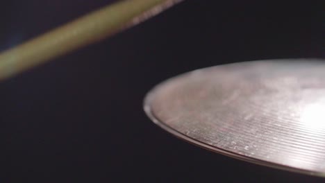 smooth close up of a shiny drum hi-hat being played with sticks