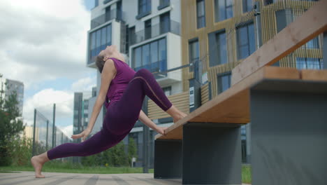 woman stretching in urban park