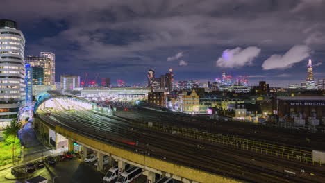 busy traffic of trains at london waterloo station at night in time-lapse from a vantage point