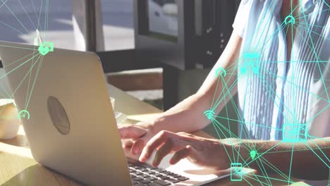 animation of connected icons forming globes over caucasian woman working on laptop