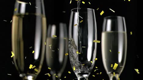 animation of gold confetti falling over glasses of champagne on black background