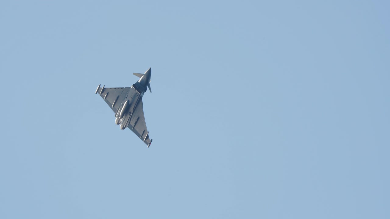 Eurofighter Typhoon Military Jet Flying and Maneuvering in Blue Sky