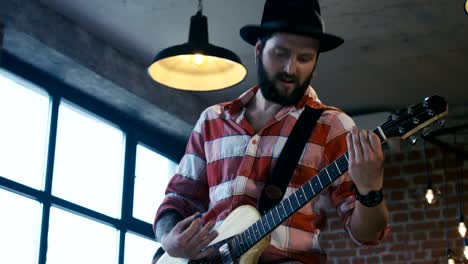 singing guitarist in hat