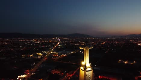 Aerial-drone-view-of-Monteagudo-Christ-castle-at-night-against-sunset-and-Murcia-cityscape-in-Spain