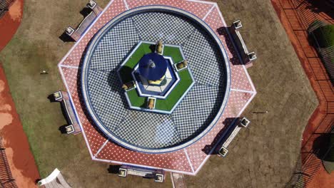 cinematic top-down drone shot of ornamental fountain in spring morning