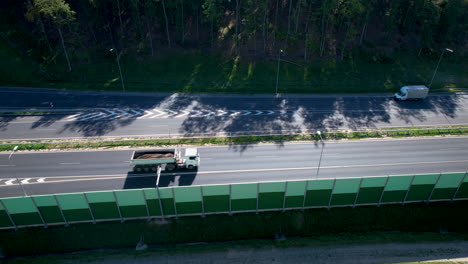 multiple vehicles drive on a multi lane road highway by the forest in wielki kack gdynia, poland