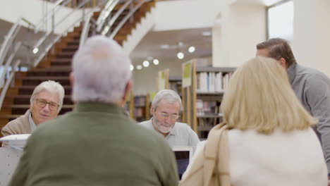 Old-people-talking-with-teacher-during-class-in-library