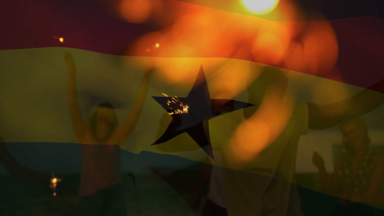 Marketing showing flag fading revealing friends dancing on beach waving sparklers celebrating unity
