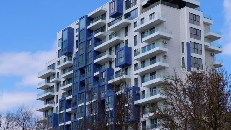 A fachada de um prédio azul e branco com o céu no plano de fundo