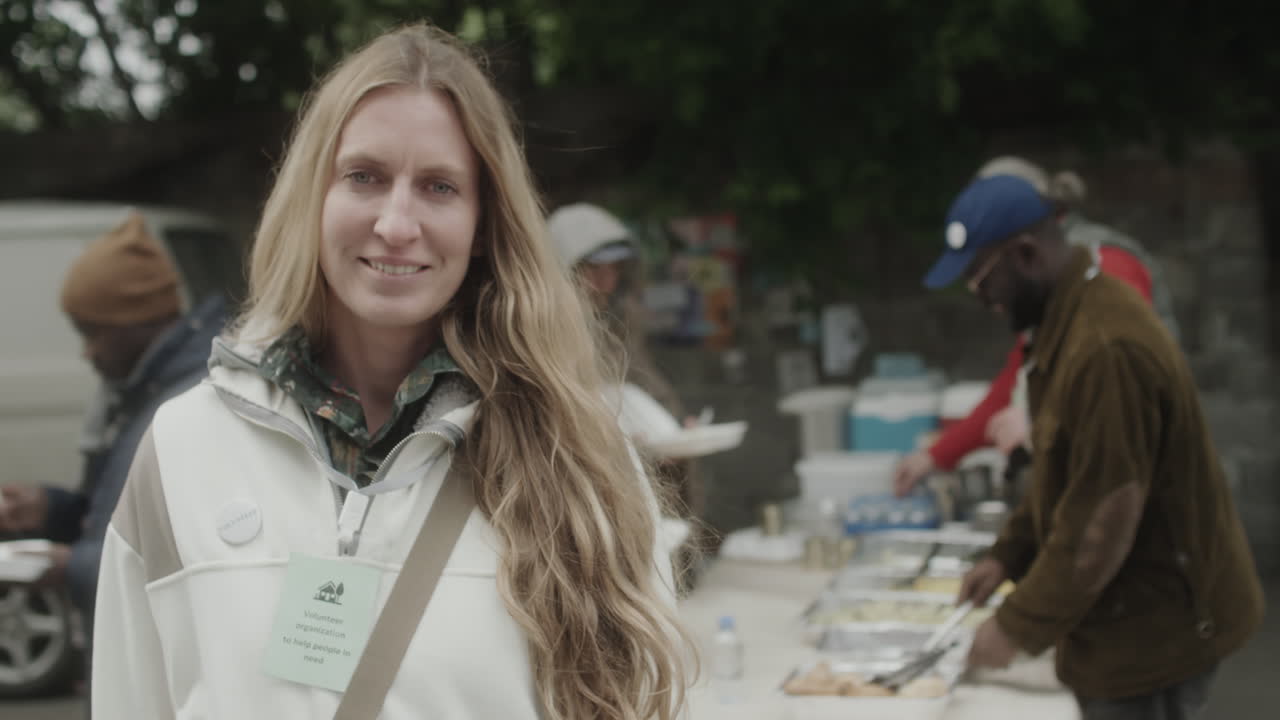 Woman volunteer smiling at a food distribution event