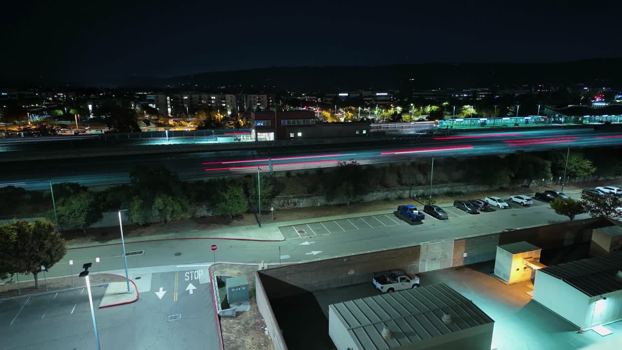 Traffic flows steadily along the 580 freeway in Dublin at dusk, captured from an elevated perspective as city lights begin to shimmer