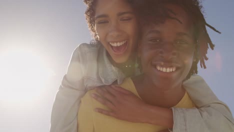 man giving piggyback ride to woman on the beach 4k