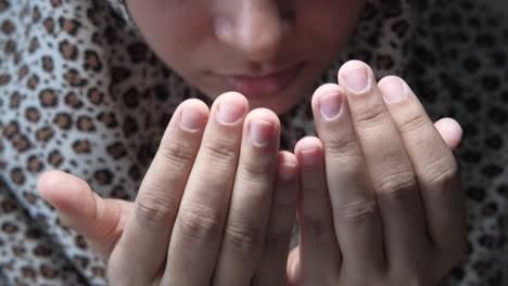 muslim women with head scarf praying, close up