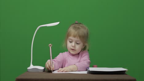 Girl-drawing-at-the-table.-Education-process.-Three-years-old-child.-Chroma-Key