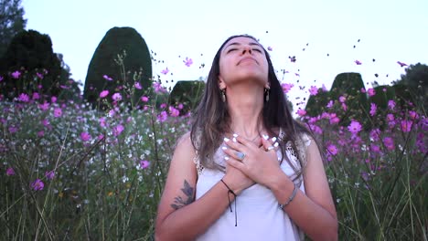 young latin woman breahting in calm in the middle of a beautiful purple field with tinny flowers