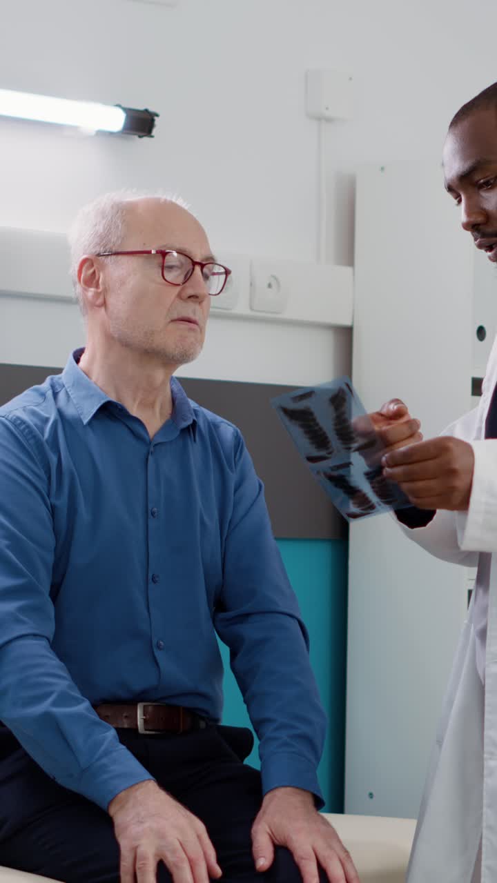 Doctor Explaining X-ray Results to Senior Patient