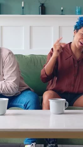 friends share laughter and music in a cozy living room setting