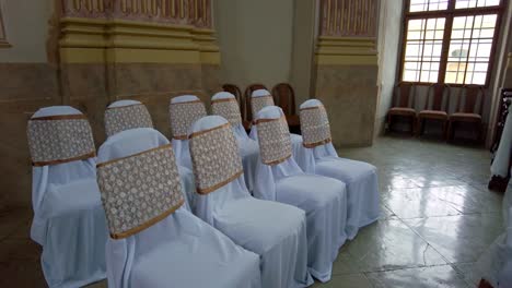 chairs in the wedding chapel covered with festive white covers ready for the wedding, slavkov u brna, česká republika