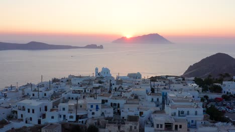 plaka village overlloking the gulf during dazzling sunset landscape, milos island greece