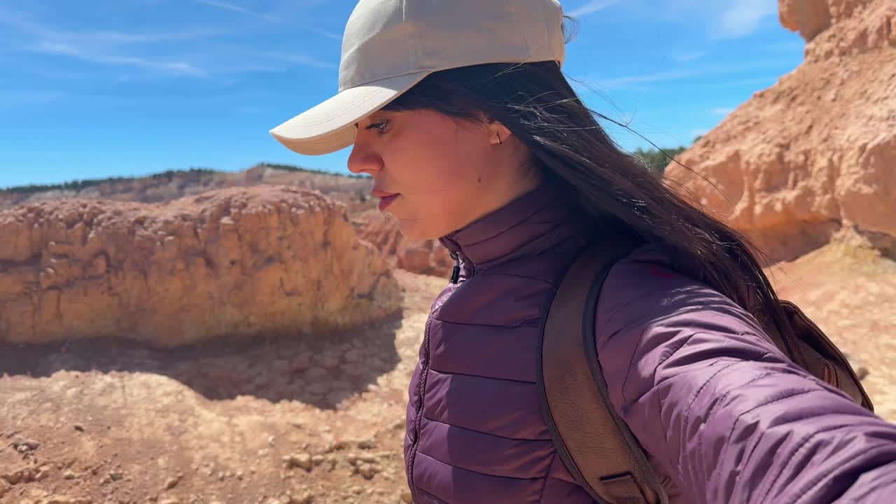 Young Woman Hiking and Exploring a Scenic Red Rock Canyon