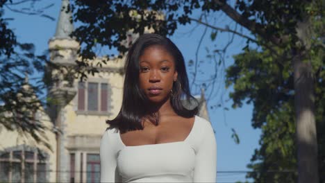 A-young-girl-in-a-white-bodysuit-savors-her-day-in-the-city-with-Stillmeyer-castles-in-the-background