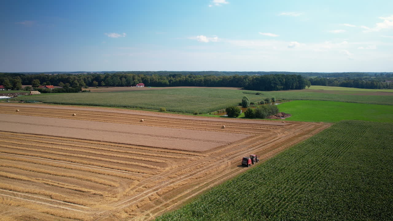 Farm Machinery Harvesting Crops In The Field In Poland - aerial drone shot