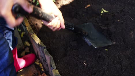 senior man digging in the soil to dig plant