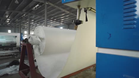 bolts of cloth of white in a textile production factory in pakistan