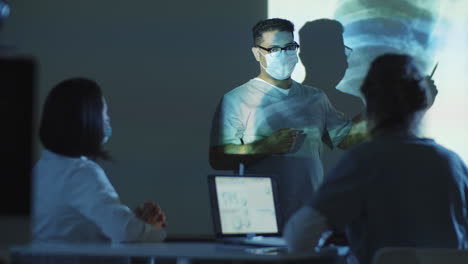 Male-Doctor-Discussing-Chest-X-Ray-with-Colleagues