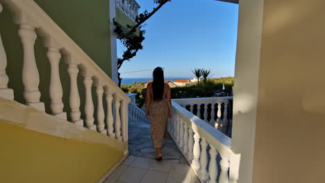 beautiful woman on vacation in greece walks out see the spectacular view