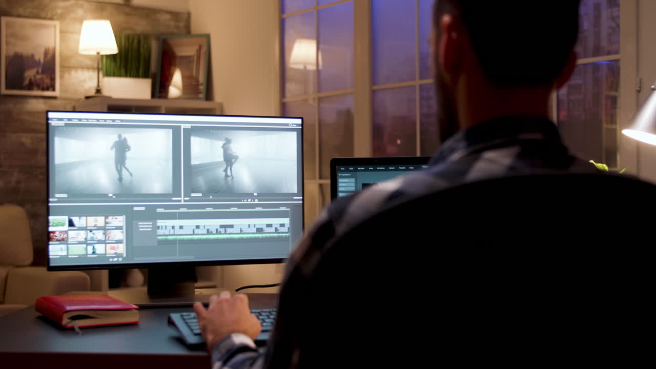 Man editing video at his workstation