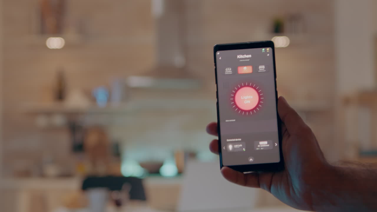 Close up of man hand holding phone with modern software controlling lights