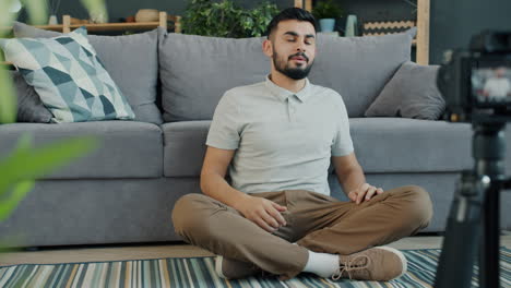 man vlogging in living room